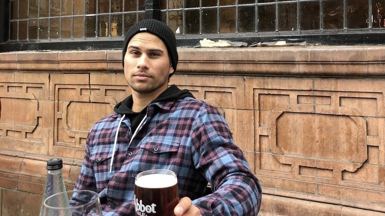 Raja Fenske, 2019 photo drinking beer, wearing a hat