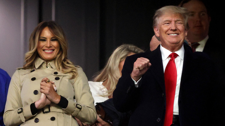 Melania Trump and Donald Trump smiling at baseball game