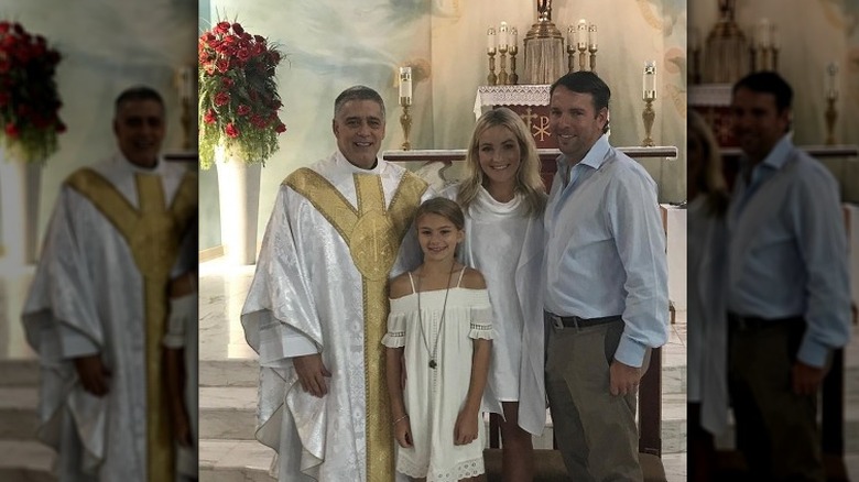 Father Mark Beard priest with Jamie, her husband, and Maddie