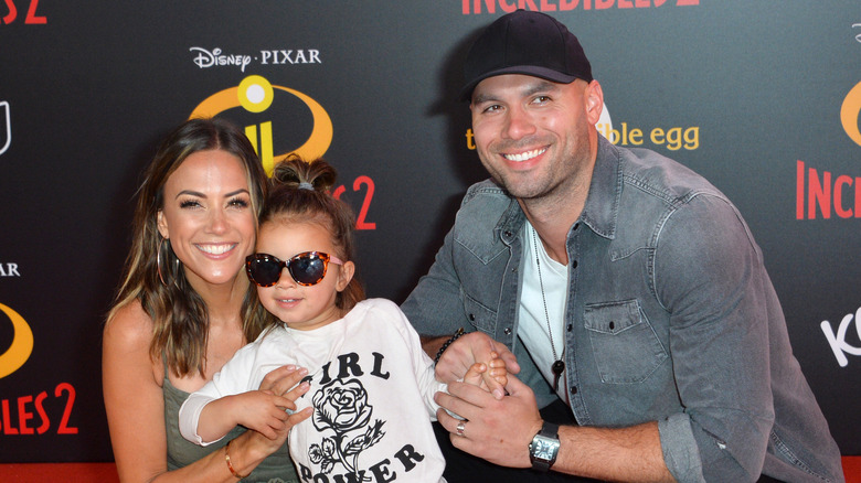 Jana Kramer, daughter Jolie, and Mike Caussin posing on red carpet