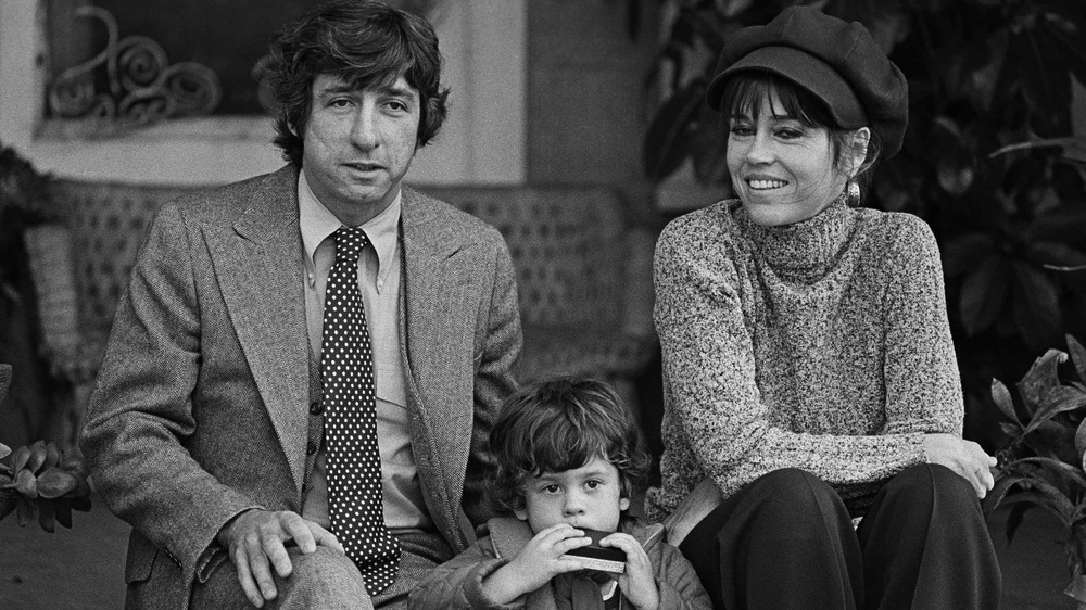 Tom Hayden and Jane Fonda posing for a photo with their young son Troy 