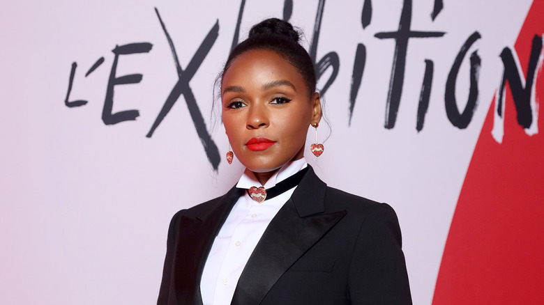 Janelle Monae posing in a black suit