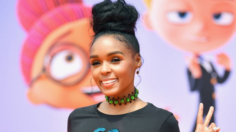 Janelle Monae posing at an event with peace sign