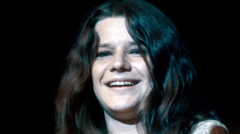 Janis Joplin black with dark eyeshadow laughing