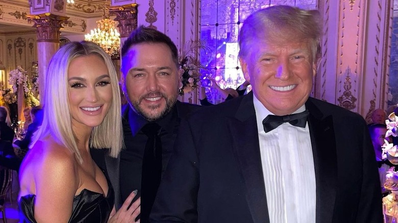 Jason Aldean, Brittany Aldean, and Donald Trump smiling