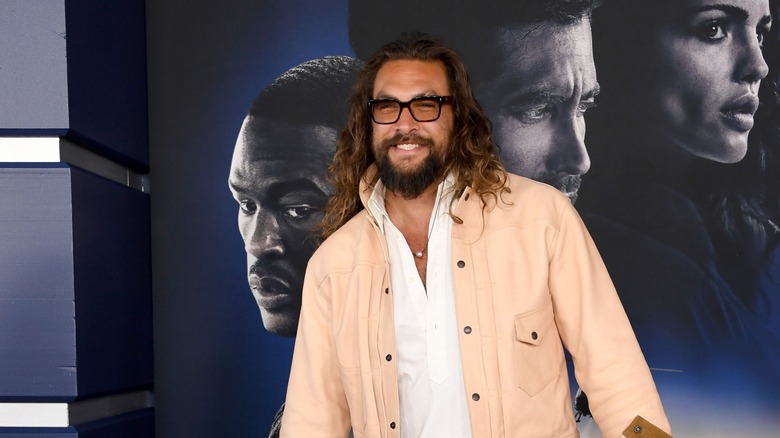 Jason Momoa poses, smiles