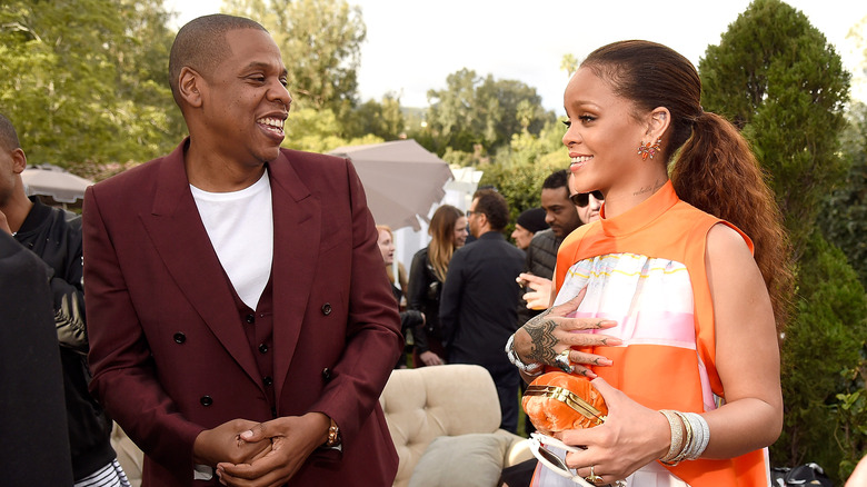 Rihanna Jay-Z smiling high fiving