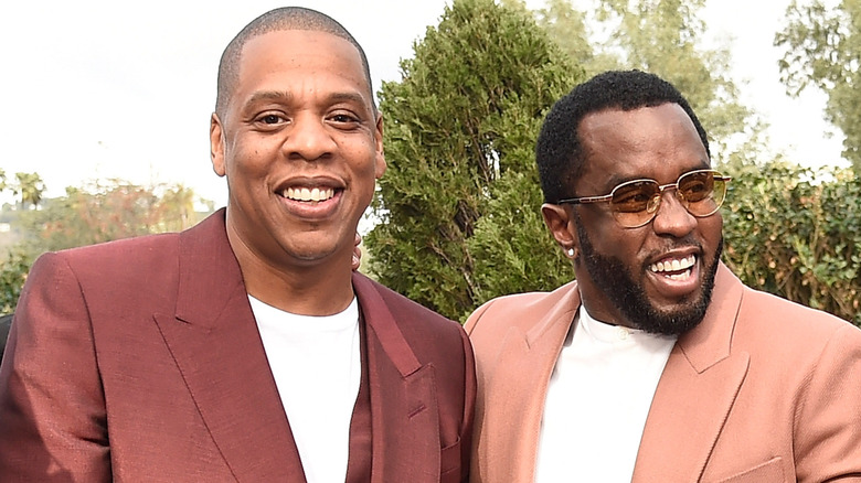 Jay-Z and Diddy smile together in tan and peach suits