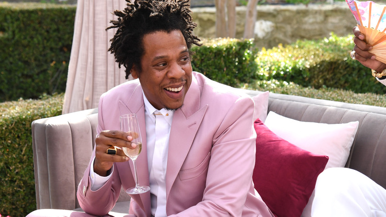 Jay-Z holding a glass of champagne