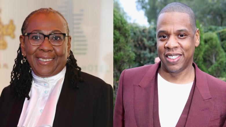 Gloria Carter wears a black blazer, Jay-Z wears a maroon suit