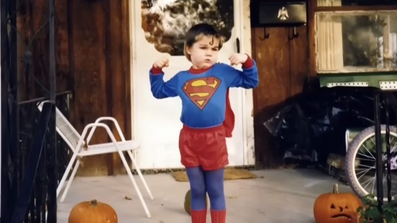 JD Vance as a child posing in a Superman costume