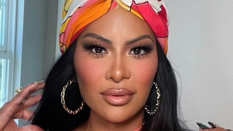 Jen Shah bright headdress and hoop earrings