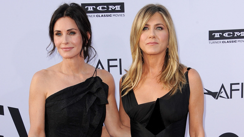 Courteney Cox and Jennifer Aniston pose 