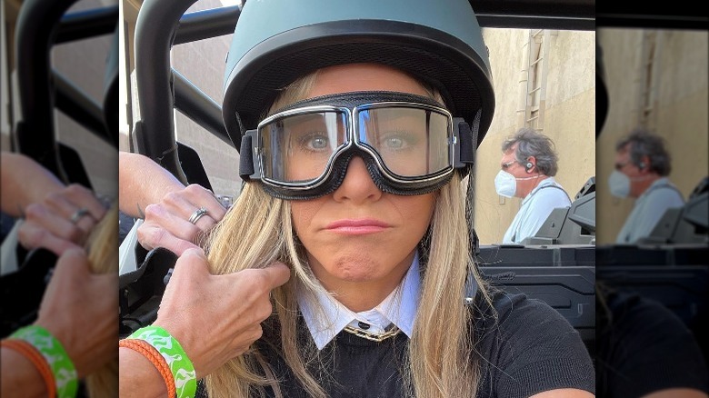 Jennifer Aniston frowning in goggles