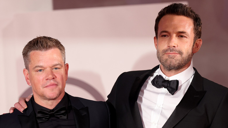 Matt Damon and Ben Affleck embracing at an event