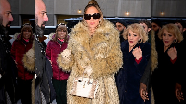 Jennifer Lopez posing with a Hermès Birkin bag