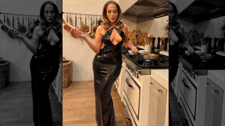 Jennifer Lopez in black dress cooking