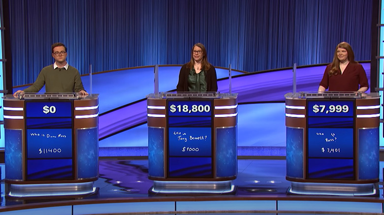 Three Jeopardy contestants behind podiums