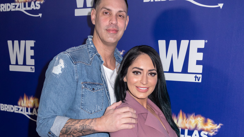 Chris Larangeira and Angelina Pivarnick posing at an event