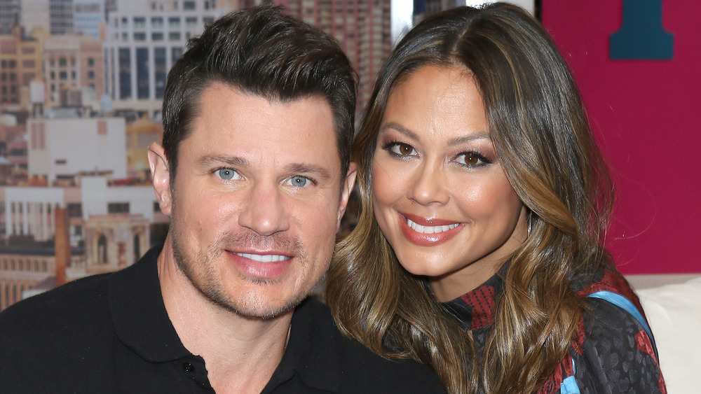 Nick and Vanessa Lachey smiling on set