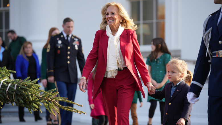 Jill Biden holding hands with Beau Biden Jr. while wearing red