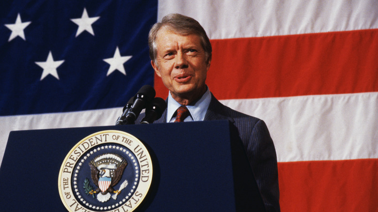 Jimmy Carter speaks to Elk City citizens with American flag behind him