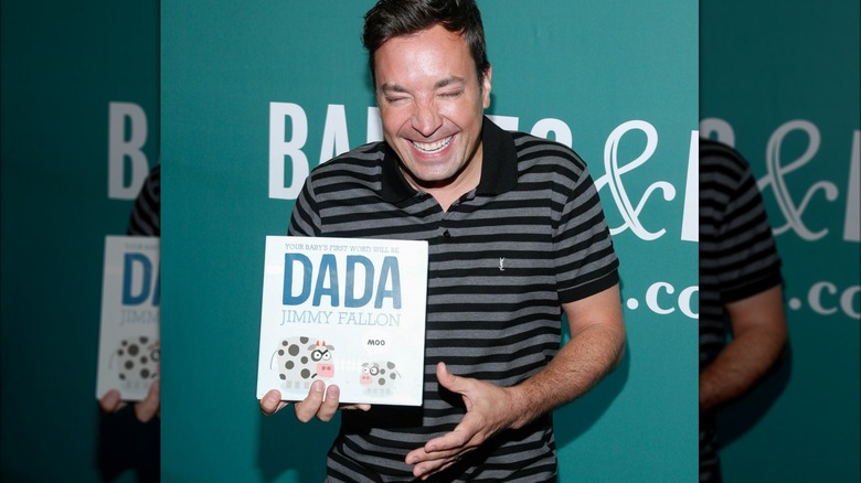 Jimmy Fallon laughing with children's book