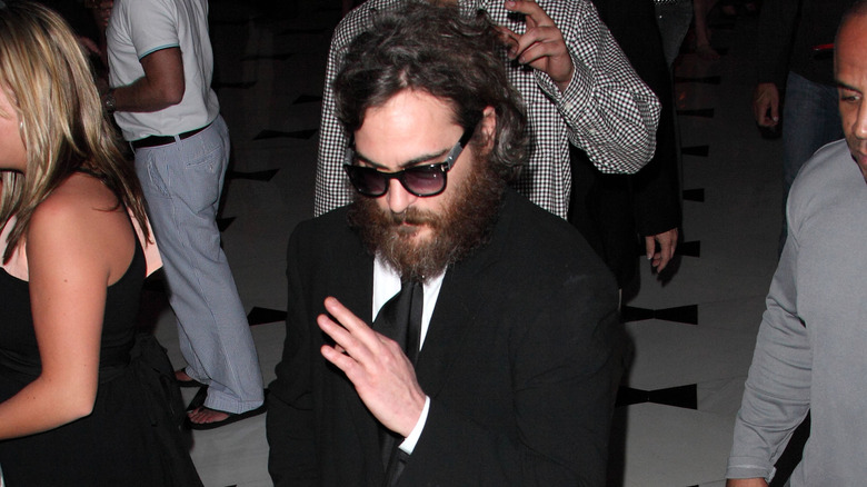 Joaquin Phoenix avoids people in a crowd