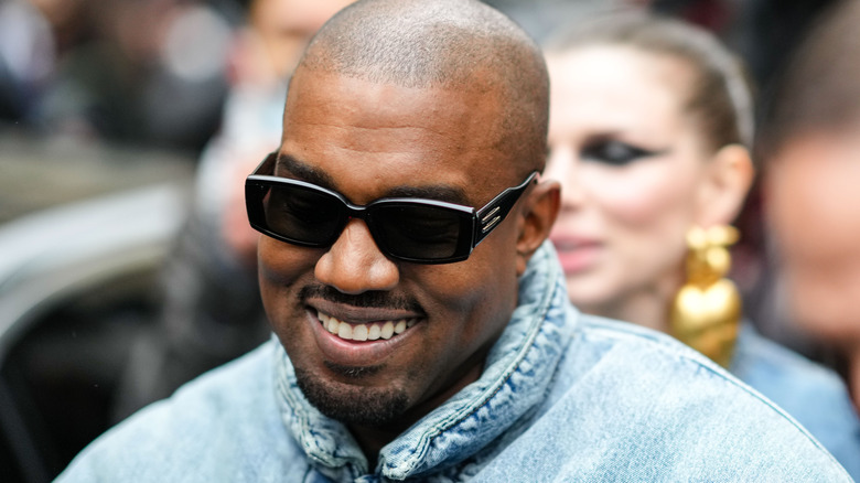 Kanye West smiling in shades