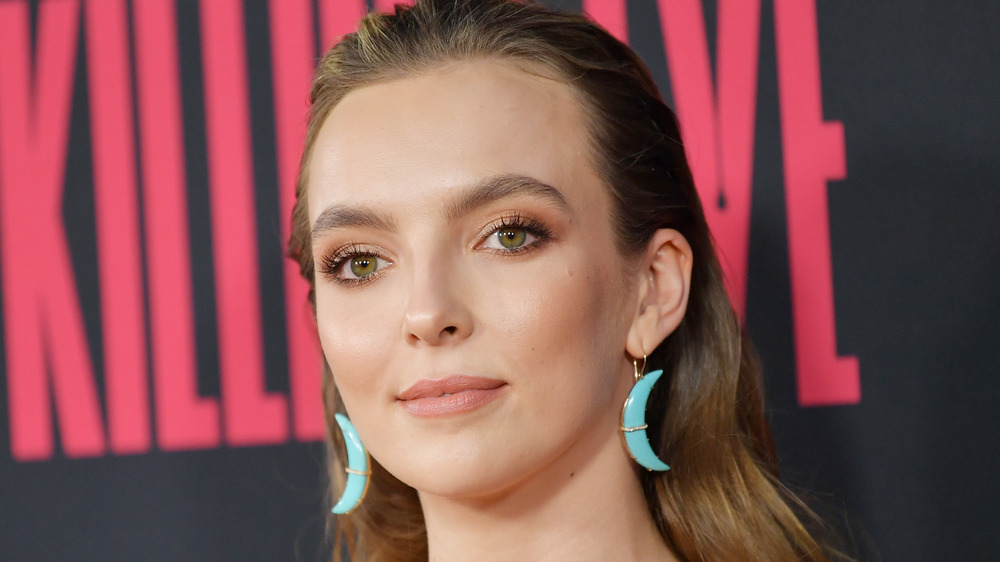 Jodie Comer smiling slightly