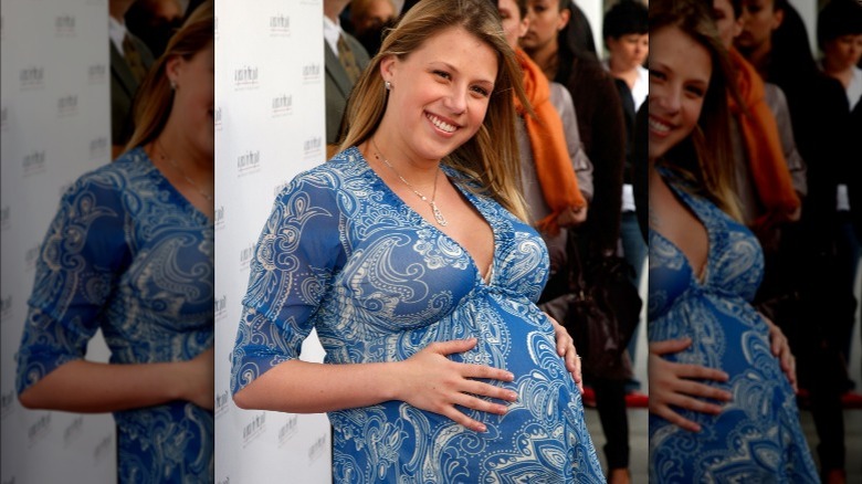 Jodie Sweetin cradling baby bump