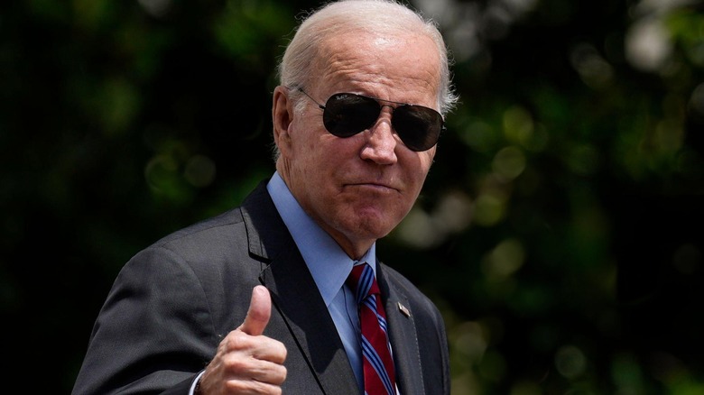 Joe Biden wearing shades while giving a thumbs up