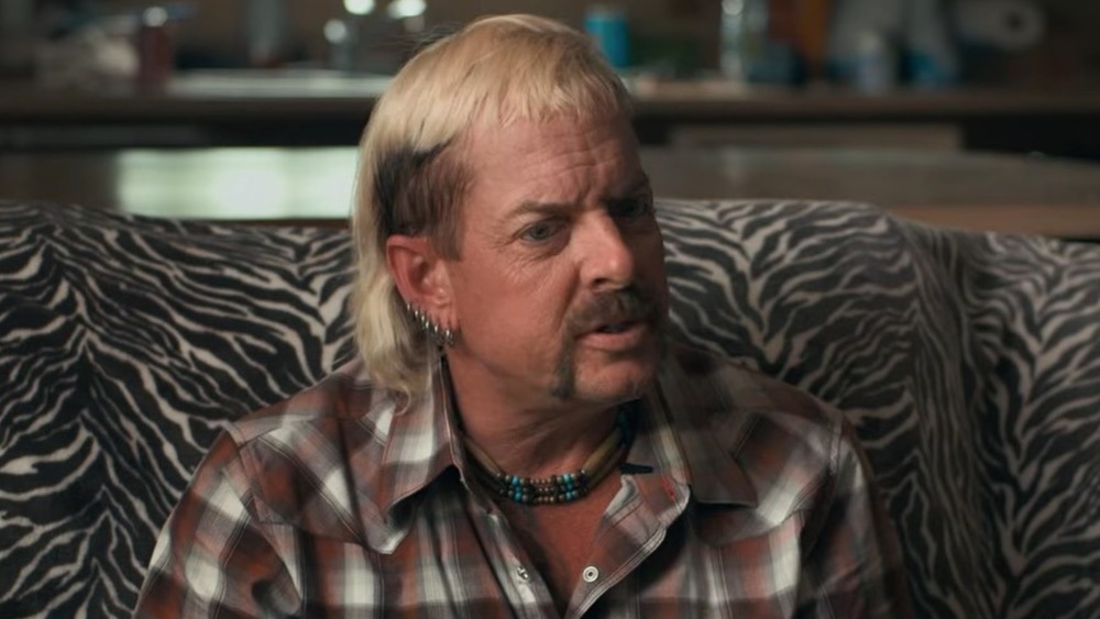 Joe Exotic sitting on a couch 