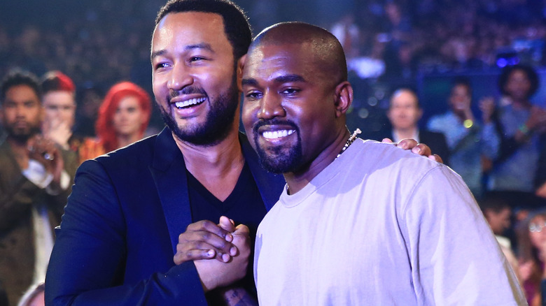 John Legend and Kanye West embrace in 2015