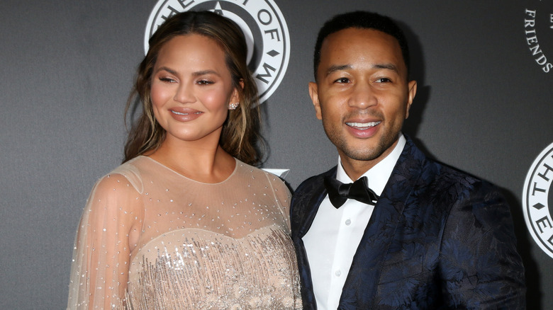 John Legend and Chrissy Teigen pose 