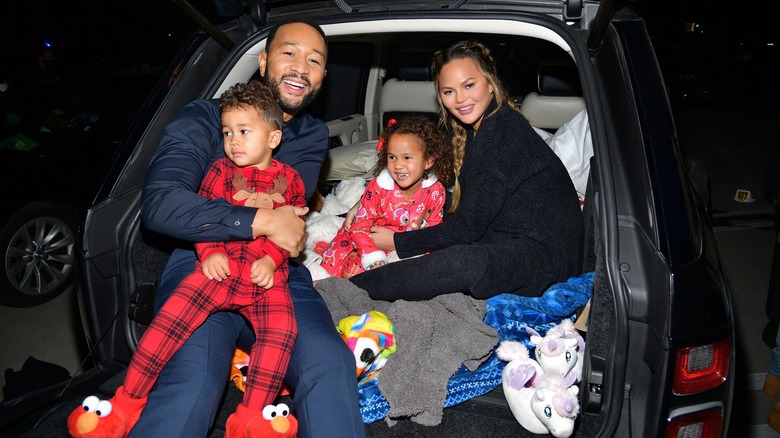 John Legend and Chrissy Teigen posing with kids