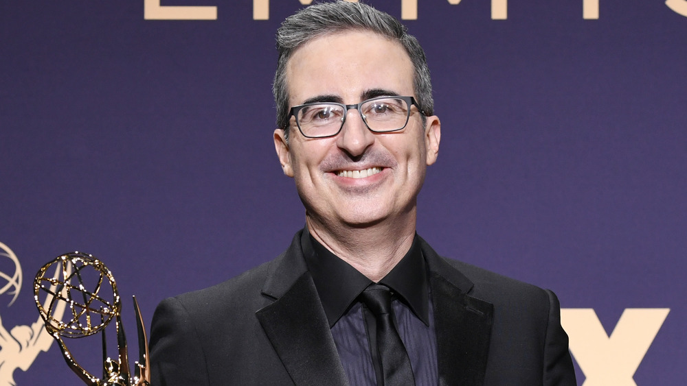 John Oliver smiling at an event