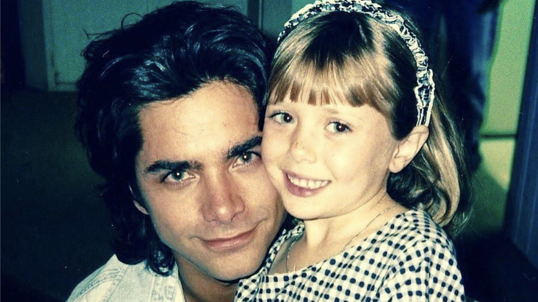 John Stamos and Elizabeth Olsen posing