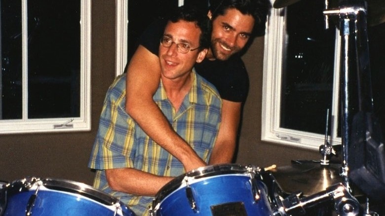 John Stamos with his arms around Bob Saget