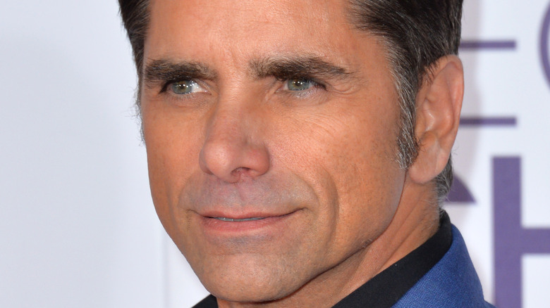 John Stamos posing for a picture