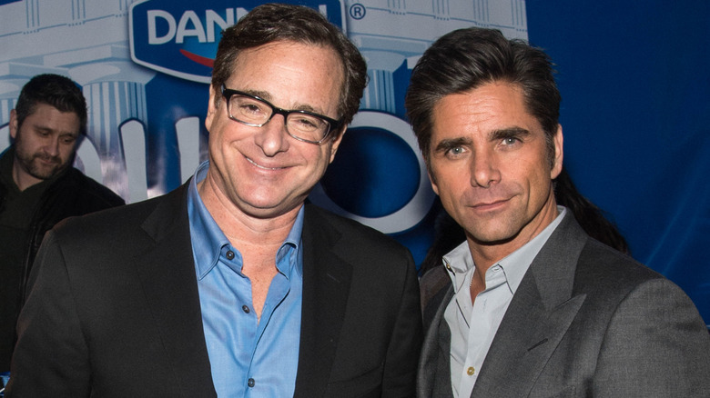 Bob Saget and John Stamos posing at an event