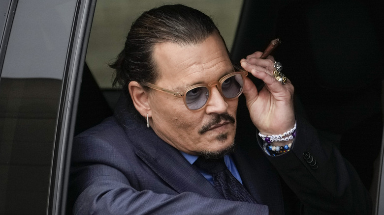 Johnny Depp adjusting sunglasses