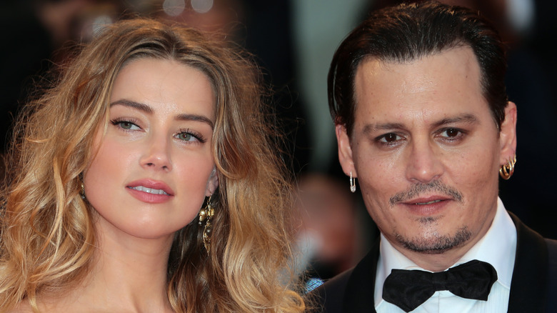 Johnny Depp and Amber Heard pose at an event