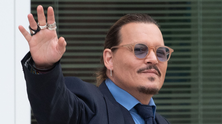 Johnny Depp winking and waving