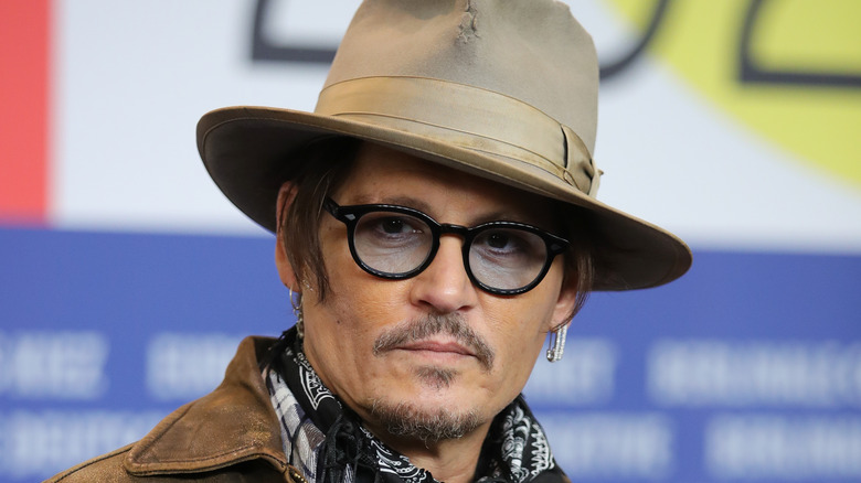 Johnny Depp posing in a hat and glasses