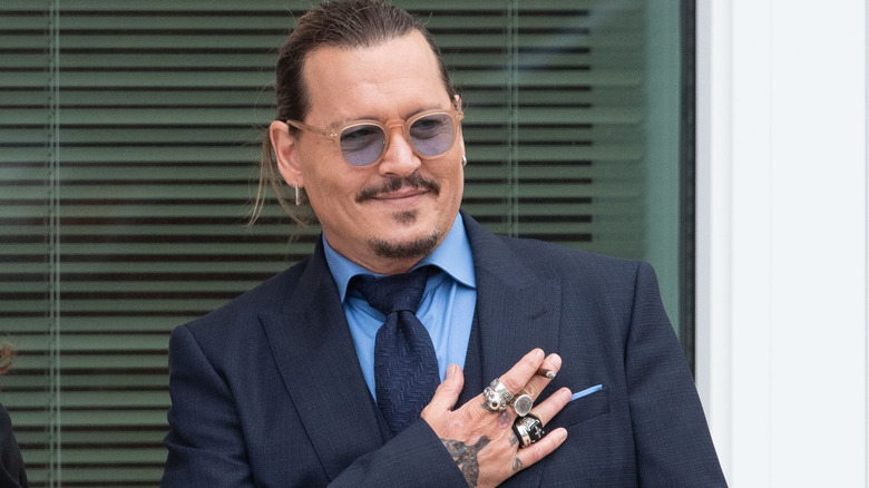 ohnny Depp gestures to fans during a recess outside court during the Johnny Depp and Amber Heard civil trial