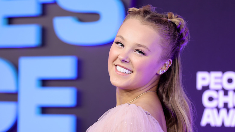 JoJo Siwa smiles over her shoulder