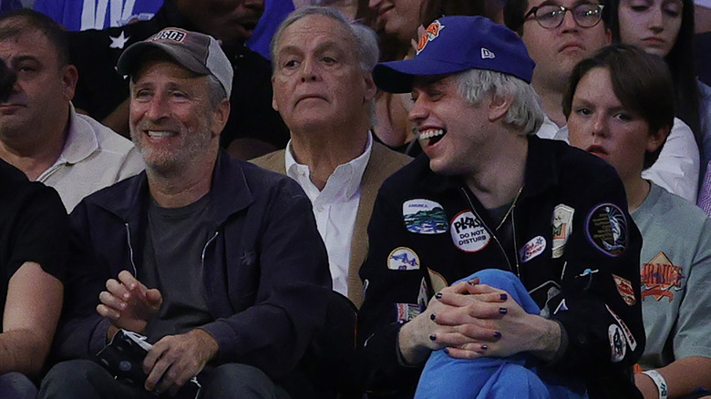 Jon Stewart and Pete Davidson laughing courtside at Madison Square Garden