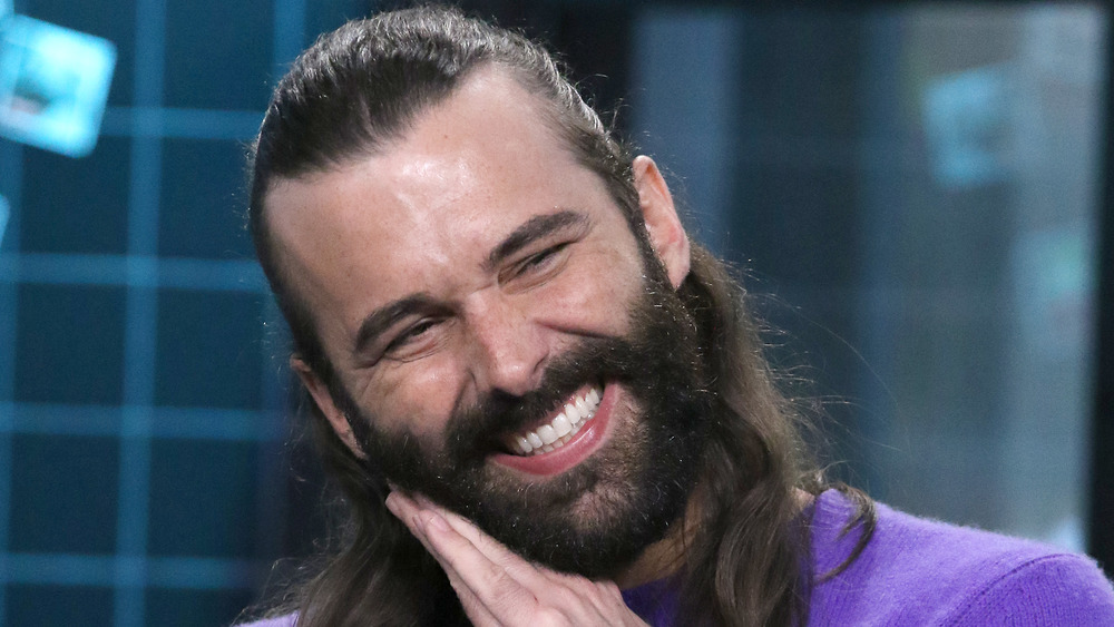 Jonathan Van Ness leaning on hands