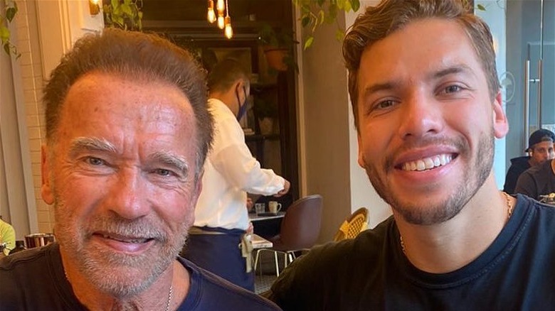 Joseph Baena toasts with dad Arnold Schwarzenegger